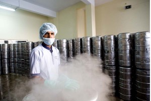 a worker mans the steam sterilizer for food vessels.